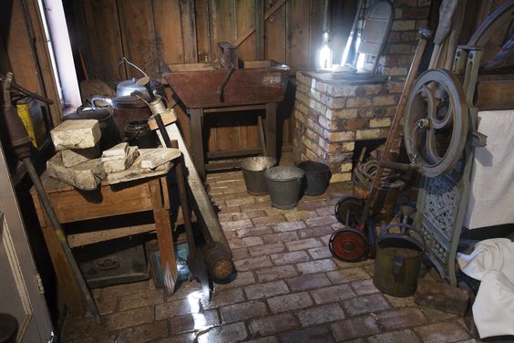 A nineteenth (XIX) century (1800s) toolshed with iron handtools, shoe repair bench, laundry press and other paraphernalia .Auckland, New Zealand